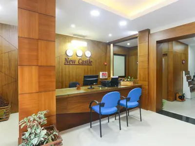 a lobby of a newcastle clinic with blue chairs at HOTEL NEWCASTLE in Vadakkāncheri