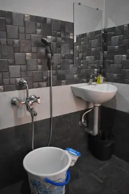 a bathroom with a toilet and a sink at DIAMOND HILL VIEW in Ketti
