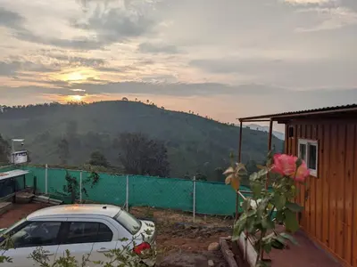 a car parked in front of a house with a mountain at DIAMOND HILL VIEW in Ketti