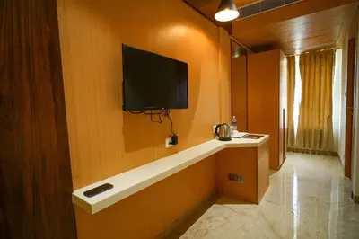 a room with a flat screen tv on a wall at Hotel Nakshathra- A Royal Stay in Palani