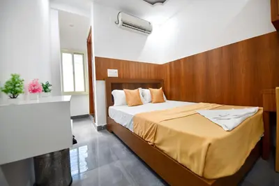 a bedroom with a bed with a wooden wall at Hotel Surya Lodge in Mysore