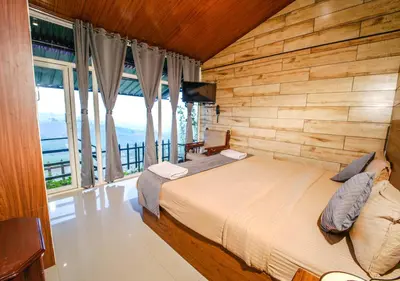 a bedroom with a bed with a wooden wall at SILENT VALLEY FARMSTEAD OOTY by VOYE HOMES in Ooty