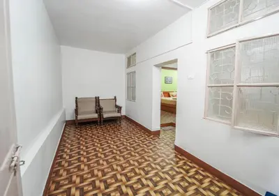 a hallway with two benches in a room with white walls at SILENT VALLEY FARMSTEAD OOTY by VOYE HOMES in Ooty