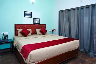 a bedroom with a large bed with red pillows at SILENT VALLEY FARMSTEAD OOTY by VOYE HOMES in Ooty