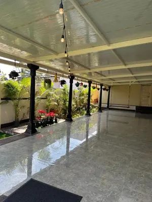 an empty lobby with plants and lights in a building at Rustic Village Farmhouse in Bengaluru