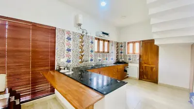 a kitchen with a wooden counter top in a room at Mountain Mansion Kodai in Kodaikānāl