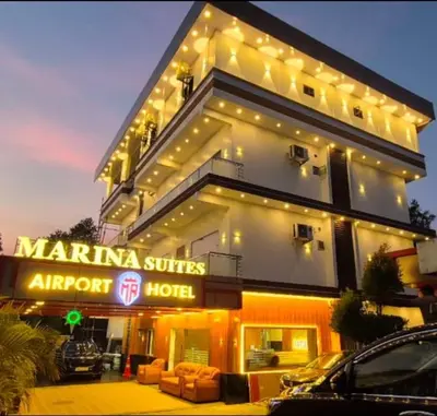a large building with a hotel with cars parked in front at MARINA SUITES AIRPORT HOTEL in Cochin