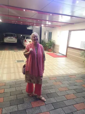 a woman is standing in a parking garage at MARINA SUITES AIRPORT HOTEL in Cochin