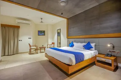 a bedroom with a large bed and a table at HOTEL CASON INTERNATIONAL in Kondotti