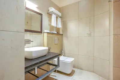 a bathroom with a sink and a toilet at HOTEL CASON INTERNATIONAL in Kondotti