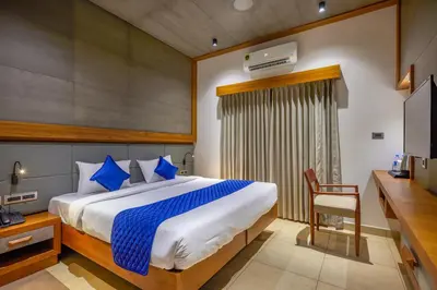 a bedroom with a bed and a desk and a television at HOTEL CASON INTERNATIONAL in Kondotti