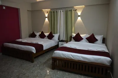 two beds in a hotel room next to each other at Dreams Paradise Airport Residency in Nedumbassery