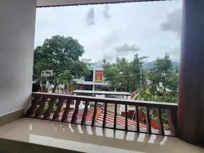 a balcony with a view of a building at Navarang Villa in Kalpetta