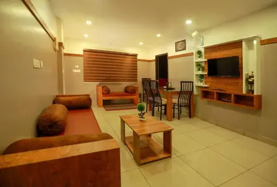 a living room with a couch and a table at The Rosetta Castle in Kalpetta