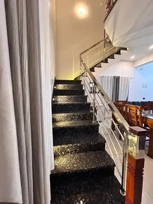 a staircase in a house with a curtain at ENOCEAN HOMESTAY in Cherai Beach