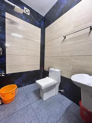 a bathroom with a toilet and a sink at ENOCEAN HOMESTAY in Cherai Beach