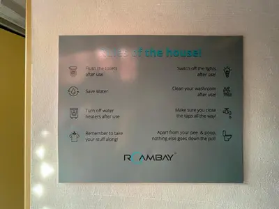 a sign on a wall with a menu for a house at Rahees Bi Roambay - Backpacker Hostel in Mysore