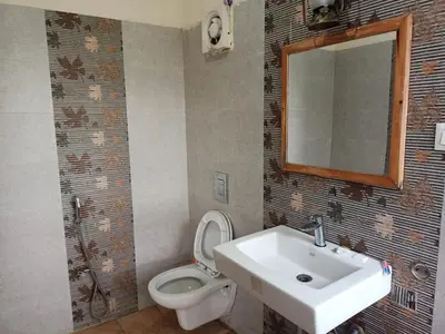 a bathroom with a sink and a toilet and a mirror at MOUNTAIN OF MAGICS in Ooty