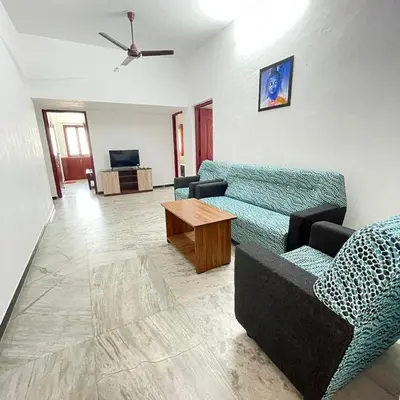 a living room with a couch and a table at WHITE HOUSE - 3BHK Elegant Apartment in Coimbatore