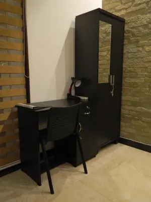 a black desk in a room with a door at Torch Ginger Homestay in Sultan Bathery