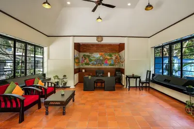 a living room with couches and a table at The Hive, Wayanad in Wayanad