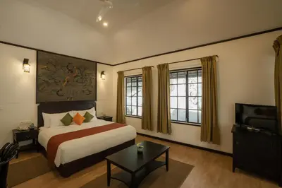 a hotel room with a bed and a television at The Hive, Wayanad in Wayanad