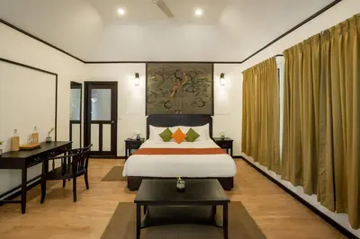a hotel room with a bed and a desk and a desk at The Hive, Wayanad in Wayanad