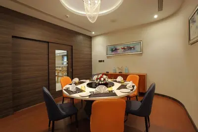 a dining room with a table and chairs at Distrikt 9 in Palakkad