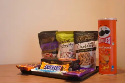 a group of snacks and a can on a table at Distrikt 9 in Palakkad
