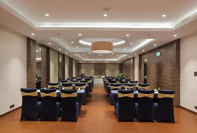 a banquet hall with chairs and tables in a room at Distrikt 9 in Palakkad