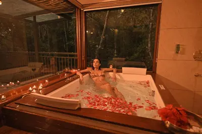 a woman sitting in a bath tub in a room at Chembarathi Wayanad Boutique Resort in Vaduvanchal