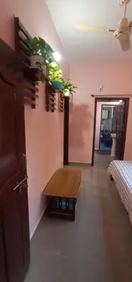 a room with a table and plants on the wall at Nakshatra Homestay in Madikeri