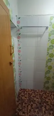 a bathroom with a shower with a glass door at Nakshatra Homestay in Madikeri