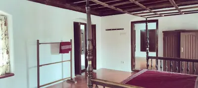 a room with a staircase and a mirror at Aramana Ayurvedic Wellness Centre & Homestay in Palakkad