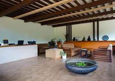 a large living room with a large bowl on the floor at Niyatma Wayanad Pool Resort by VOYE HOMES - Inside Coffee Plantation in Wayanad