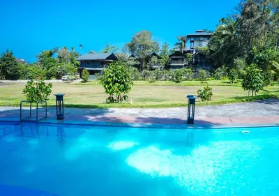 a swimming pool with two lights in the water at Niyatma Wayanad Pool Resort by VOYE HOMES - Inside Coffee Plantation in Wayanad