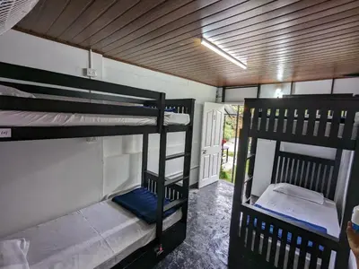 a room with two bunk beds and a hallway at Multiple Stories, Wayanad in Wayanad