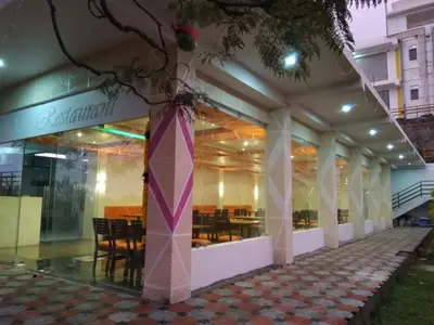 a store front of a building with tables and chairs at Belair Resorts in Kotagiri