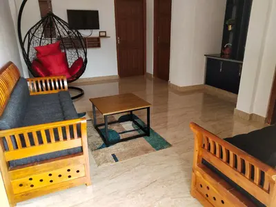 a living room with a couch and a table at Casa Maria Mystica apartments, Mananthavady, Wayanad in Mānantoddy