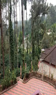 an aerial view of a house with a swimming pool at Devarakadu Valley View by StayApart in Madikeri