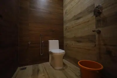 a bathroom with a toilet and a shower stall at HYDEPARK REGENCY in Palakkad