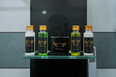 a group of three bottles of oil and a glass at Parudeesa - Heavenly- Luxurious Palace look-Near CBD - Kerala - India with Breakfast in Kāladi