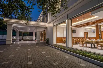 an outdoor patio of a house with tables and chairs at Hotel Panoramic in Ernakulam