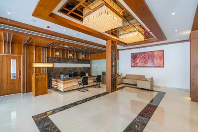 a living room with a couch and a table at Hotel Panoramic in Ernakulam