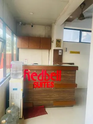 a restaurant with a redcial suites sign on a counter at Redbell Suites Calicut in Kozhikode