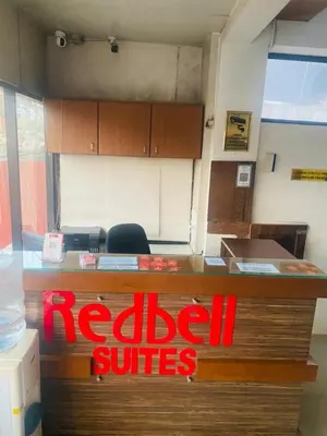 a redcial surfaces sign on a desk in an office at Redbell Suites Calicut in Kozhikode