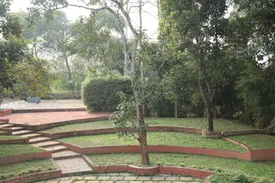 a garden with stairs and trees in a park at The Wayanad Club in Sultan Bathery