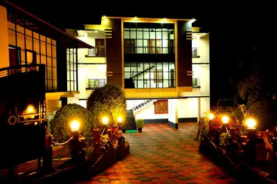 a building with lights in front of it at night at SILVERY MOON Resort in Tariyod