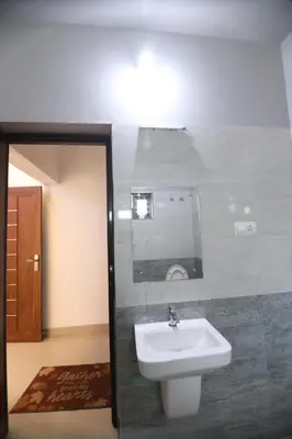 a bathroom with a sink and a mirror at SILVERY MOON Resort in Tariyod