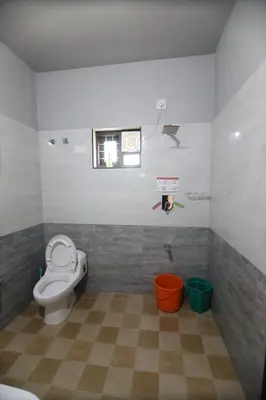 a bathroom with a toilet and a window at SILVERY MOON Resort in Tariyod